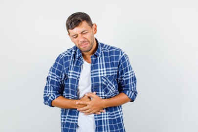 Man experiencing severe abdominal pain as a symptom of acute cholecystitis